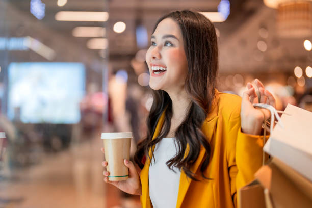 Smiling Asian female professional using smartphone